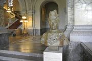 Bertha Von Suttner stands before the Peace Palace in The Hague, a historic location for international law and diplomacy.