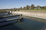 A drinking water treatment plant shows coagulation and filtration processes related to health and safe water.