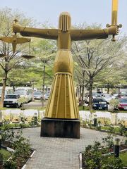 The back view of a statue at the Federal High Court of Nigeria, relating to corruption investigations.