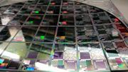 A semiconductor wafer with microelectronics is shown, illustrating advancements in technology.